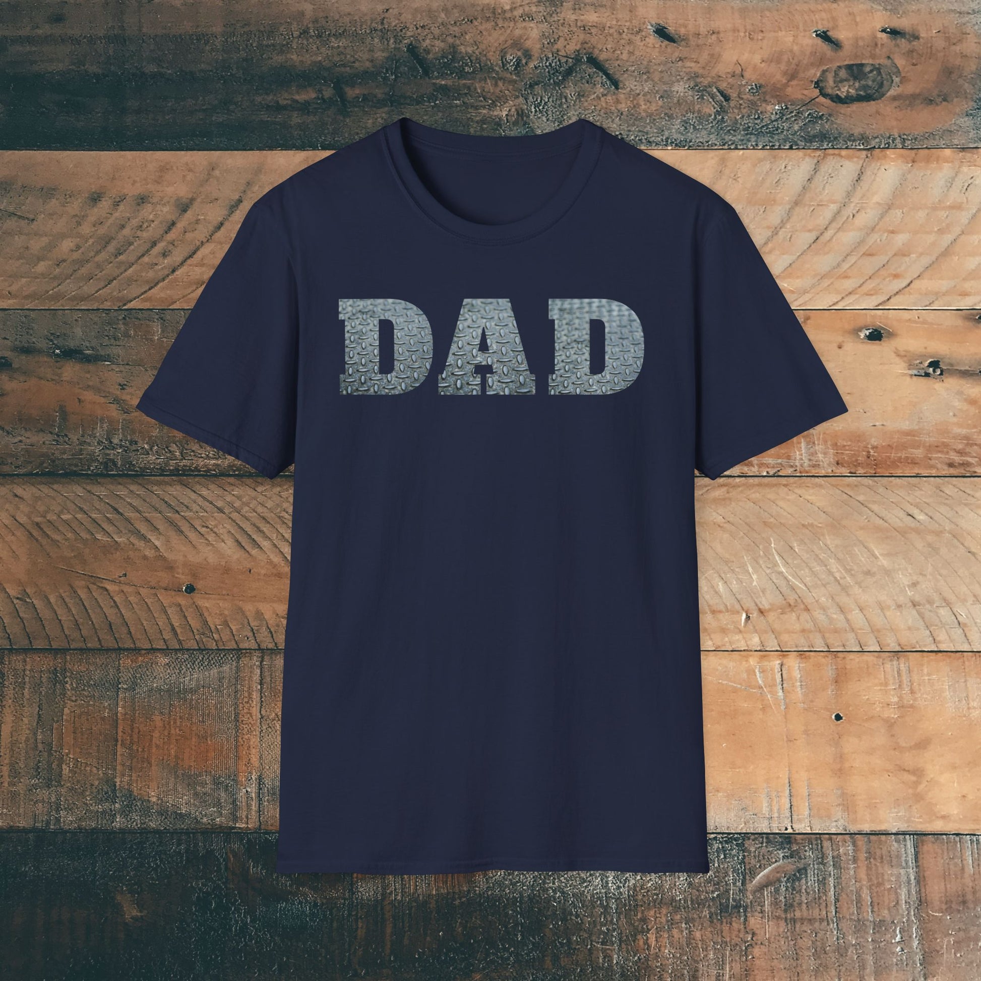 Navy blue t-shirt with 'DAD' containing silver diamond plate within text on a wooden background. Brilliantmischief.shop