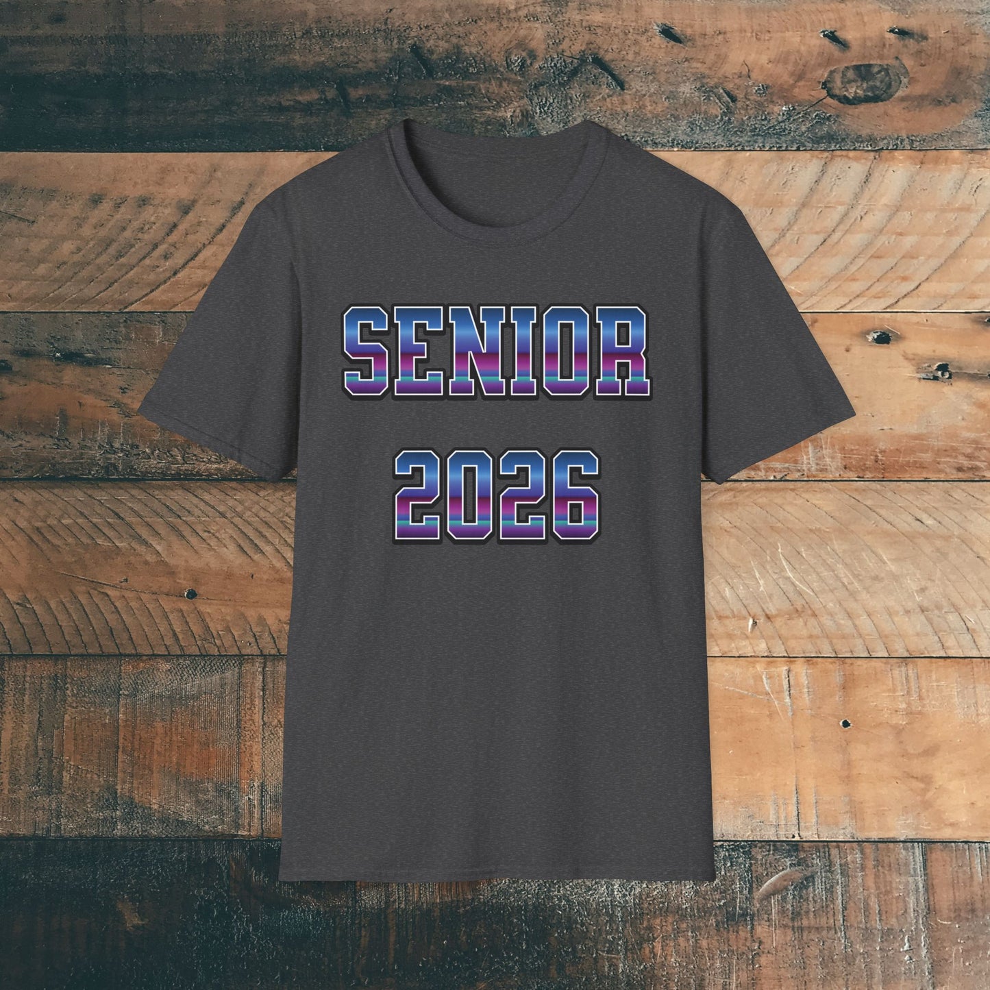 Gray t-shirt with 'SENIOR 2026' in purple and blue bold text on a wooden background. Brilliantmischief.shop