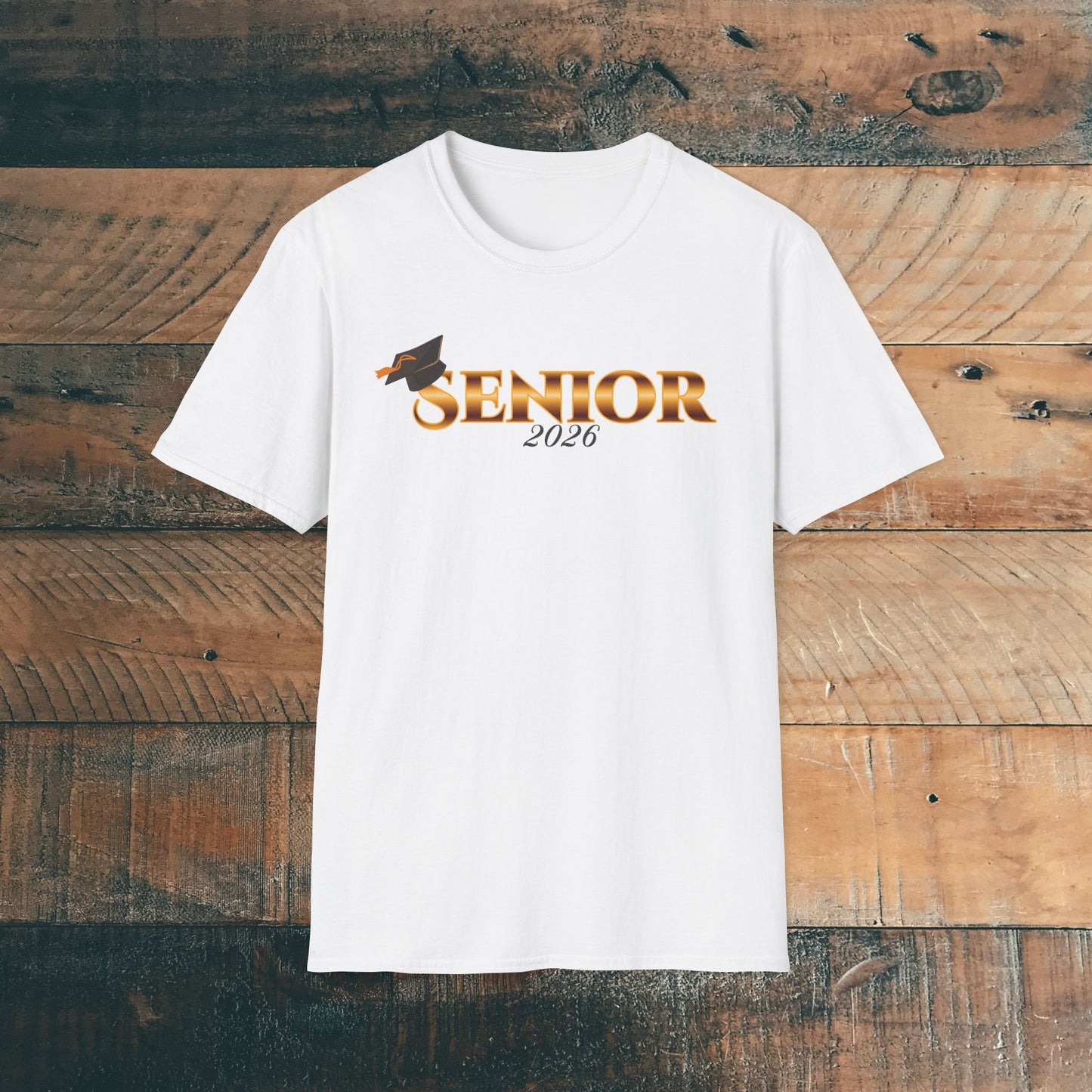 White t-shirt with 'Senior 2026' gold text design on a wooden background.
Brilliantmischief.shop
