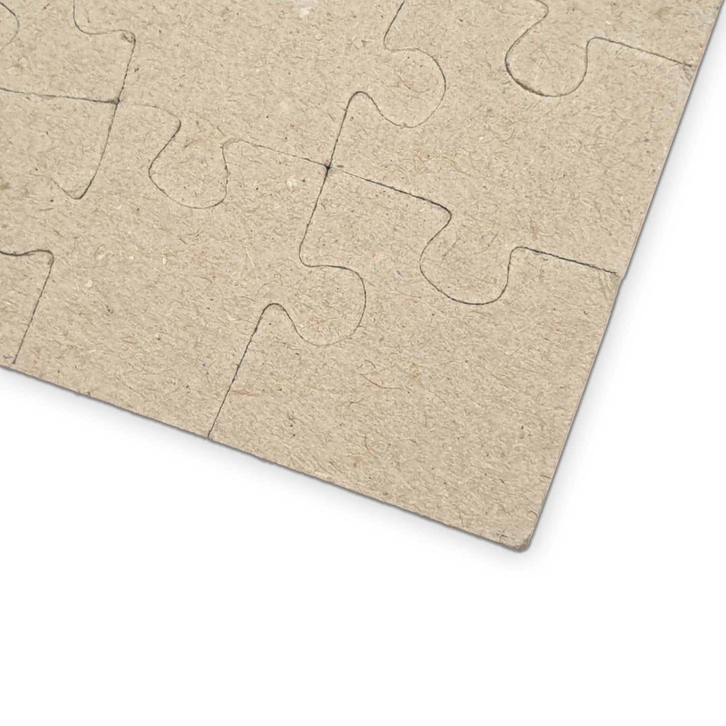 Blank cardboard puzzle pieces on a white background