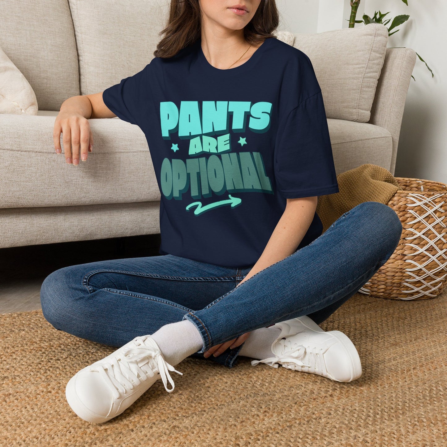Person wearing a navy blue t-shirt with 'Pants are Optional' text, sitting on the floor. Brilliantmischief.shop