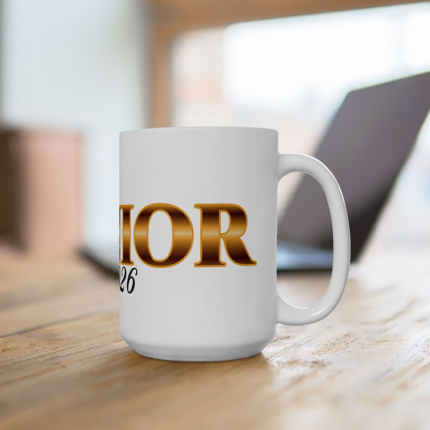 White mug on wooden surface gold text Senior black 2026 side view. Brilliantmischief.shop