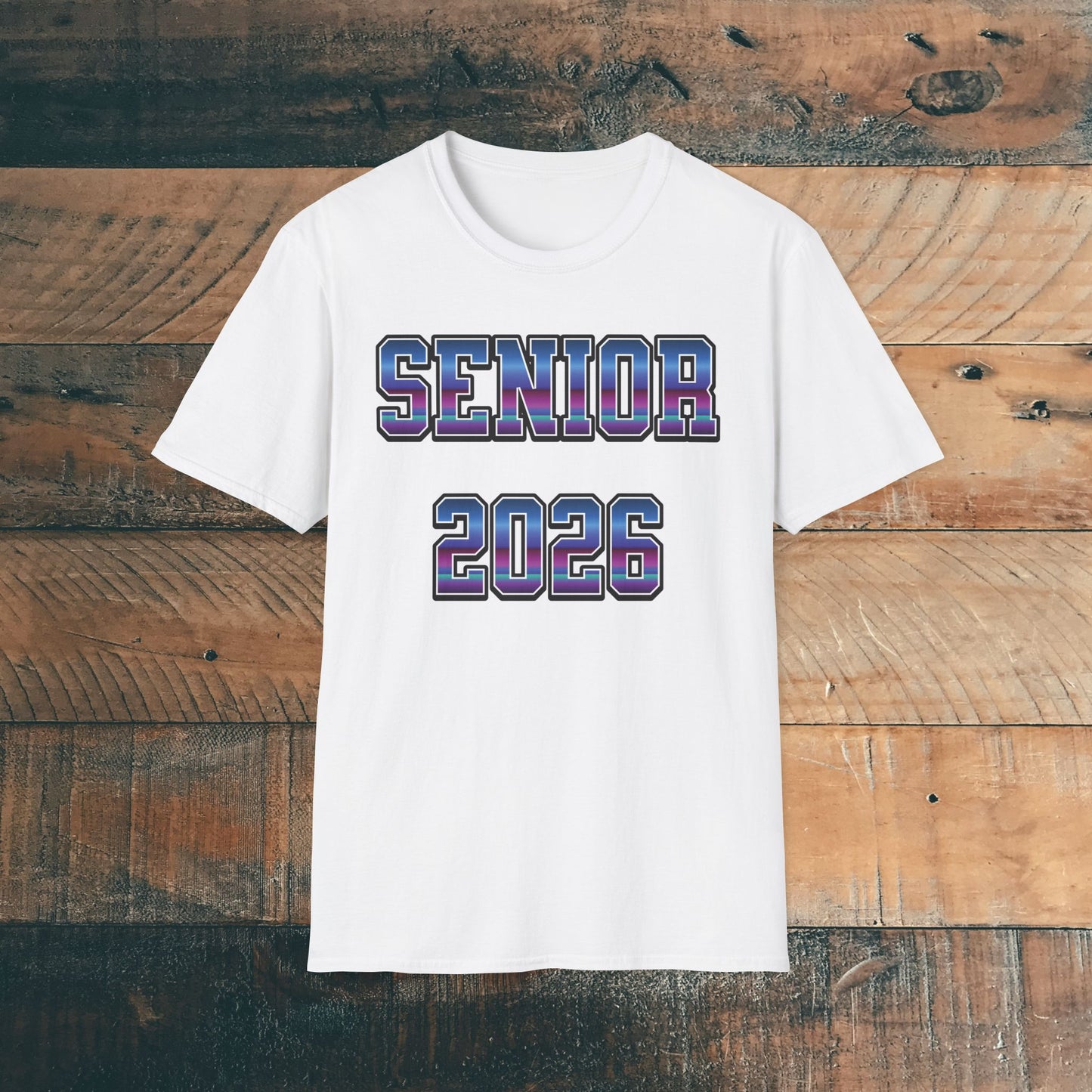 White t-shirt with 'SENIOR 2026' in purple and blue bold text on a wooden background. Brilliantmischief.shop