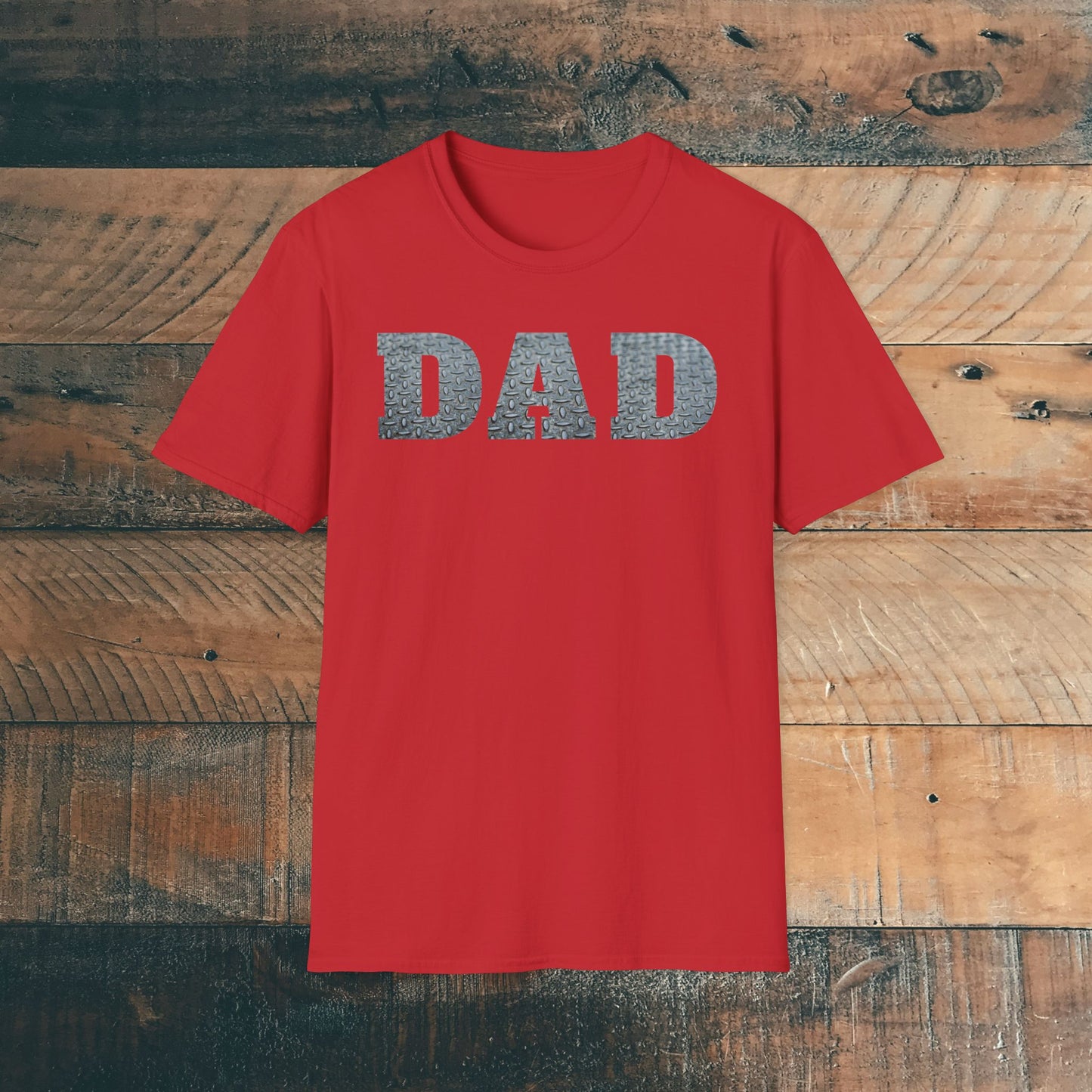 Red t-shirt with 'DAD' containing silver diamond plate within text on a wooden background. Brilliantmischief.shop